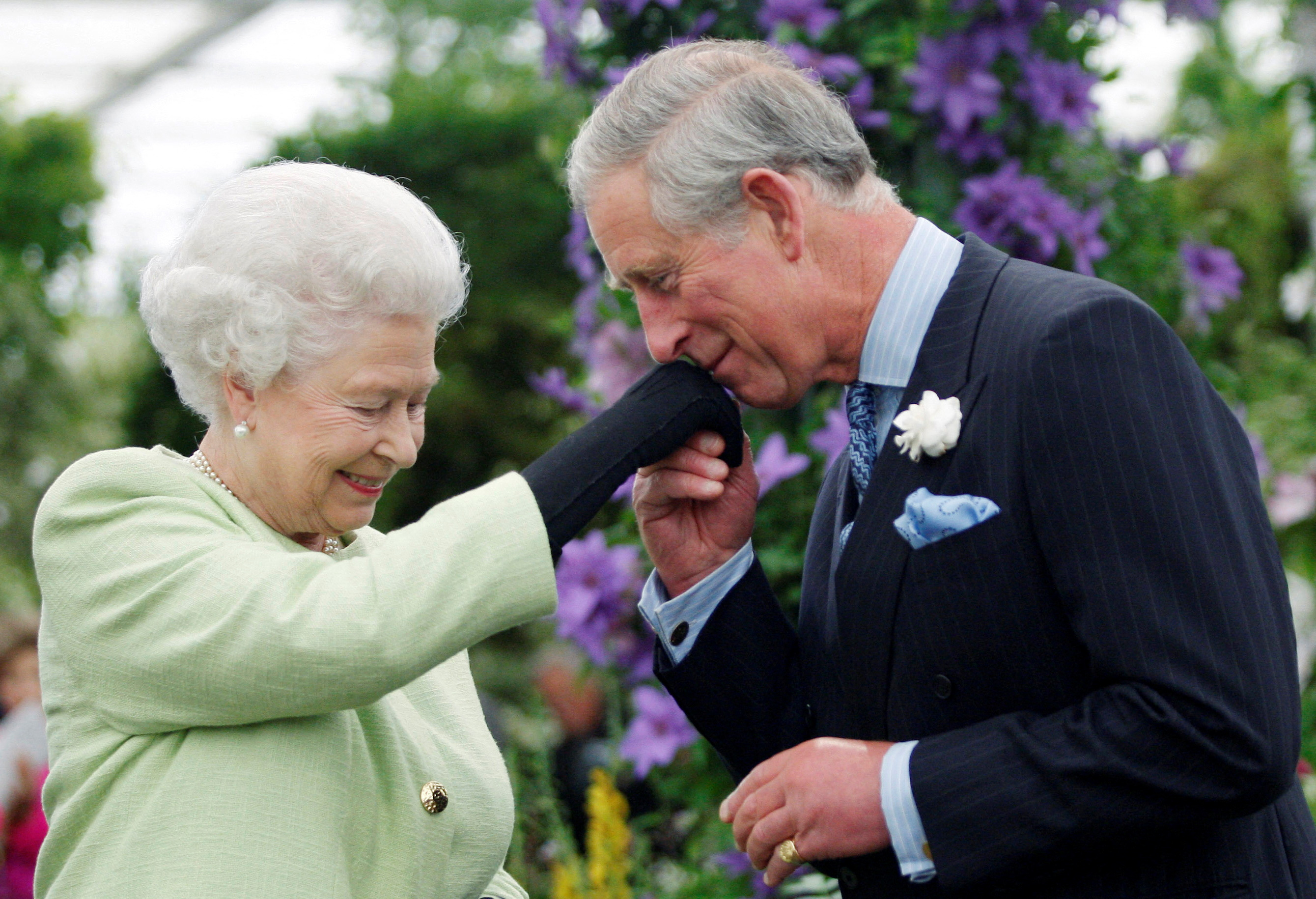 Britain's Prince Charles kisses hand of Queen Elizabeth after she presented him with Royal Horticultural Society Victoria Medal of Honour in London