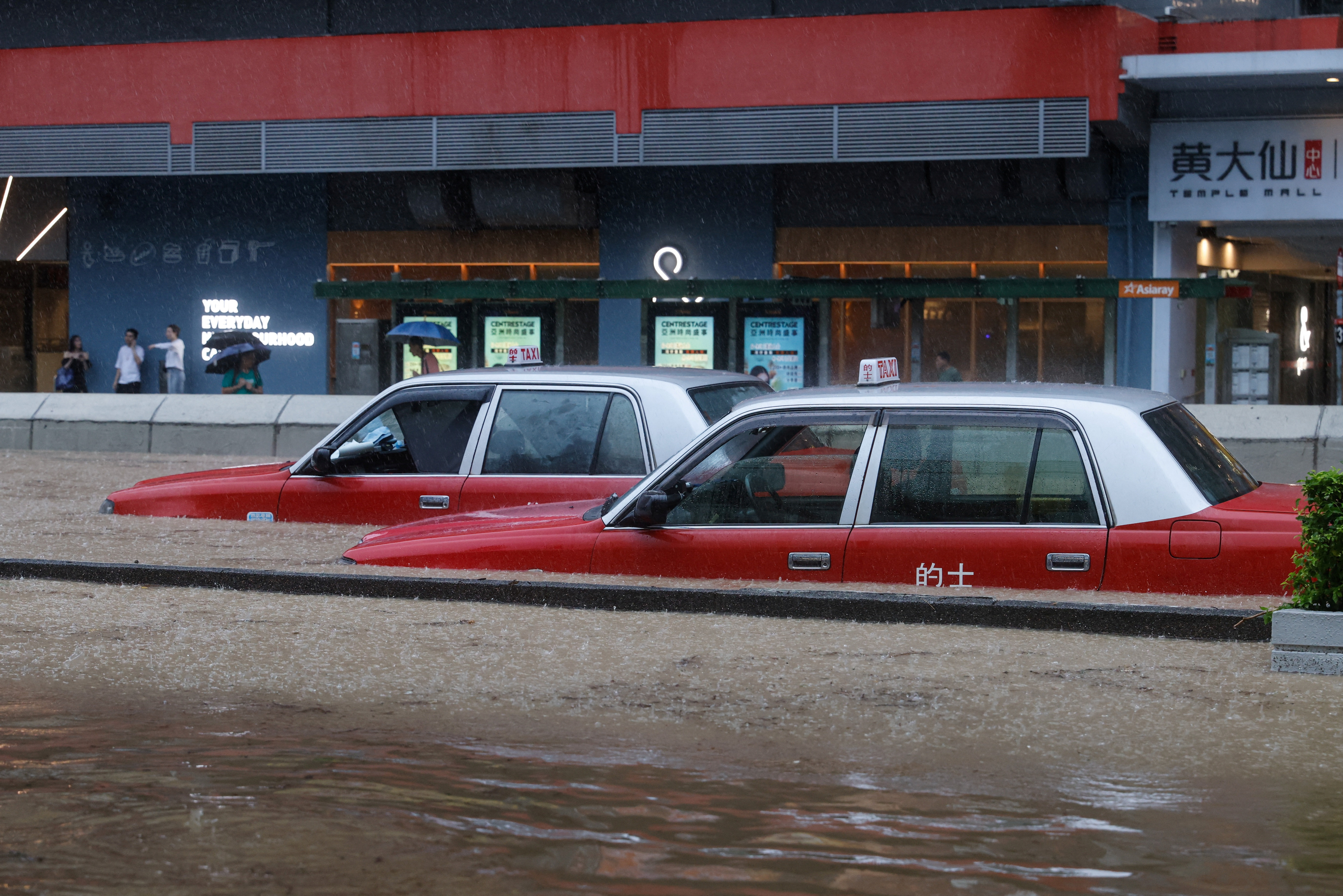 A view of cars partially submerged in flood water following heavy rains, in Hong Kong